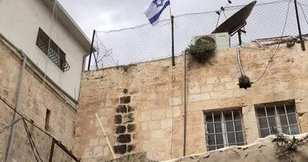 What is the story behind the house adjacent to Al-Aqsa?