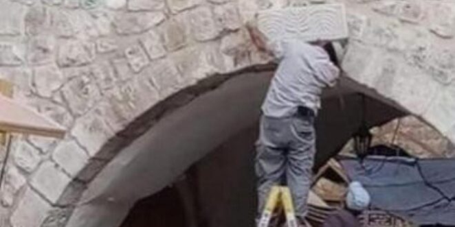 Settlers install Menorah engraved stone in the old city of Hebron