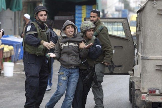 Israeli forces assault, detain 2 children on their way home from school.