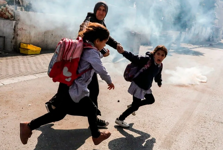 Occupied Palestine: Israeli soldiers fire tear gas and bullets at Palestinian schools