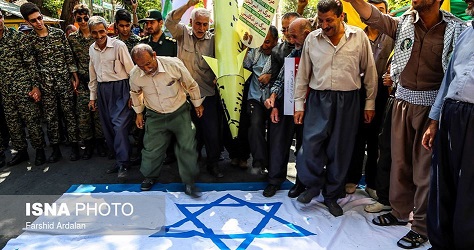 Thousands of Iranians tread on Israeli flag on Quds Day