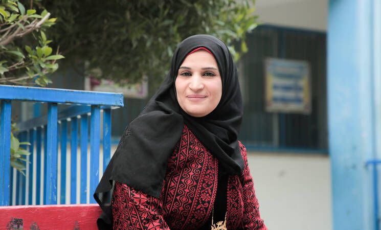 An employed woman has to bear additional burdens: First UNRWA teacher wins the gold medal for Global Creative Women Award.