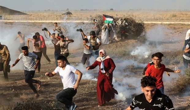 14 Gazans injured as IOF attacks protest near border fence