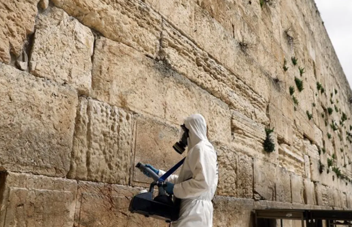 Workers in hazmat suits collect prayers from 'God's mailbox' in Jerusalem